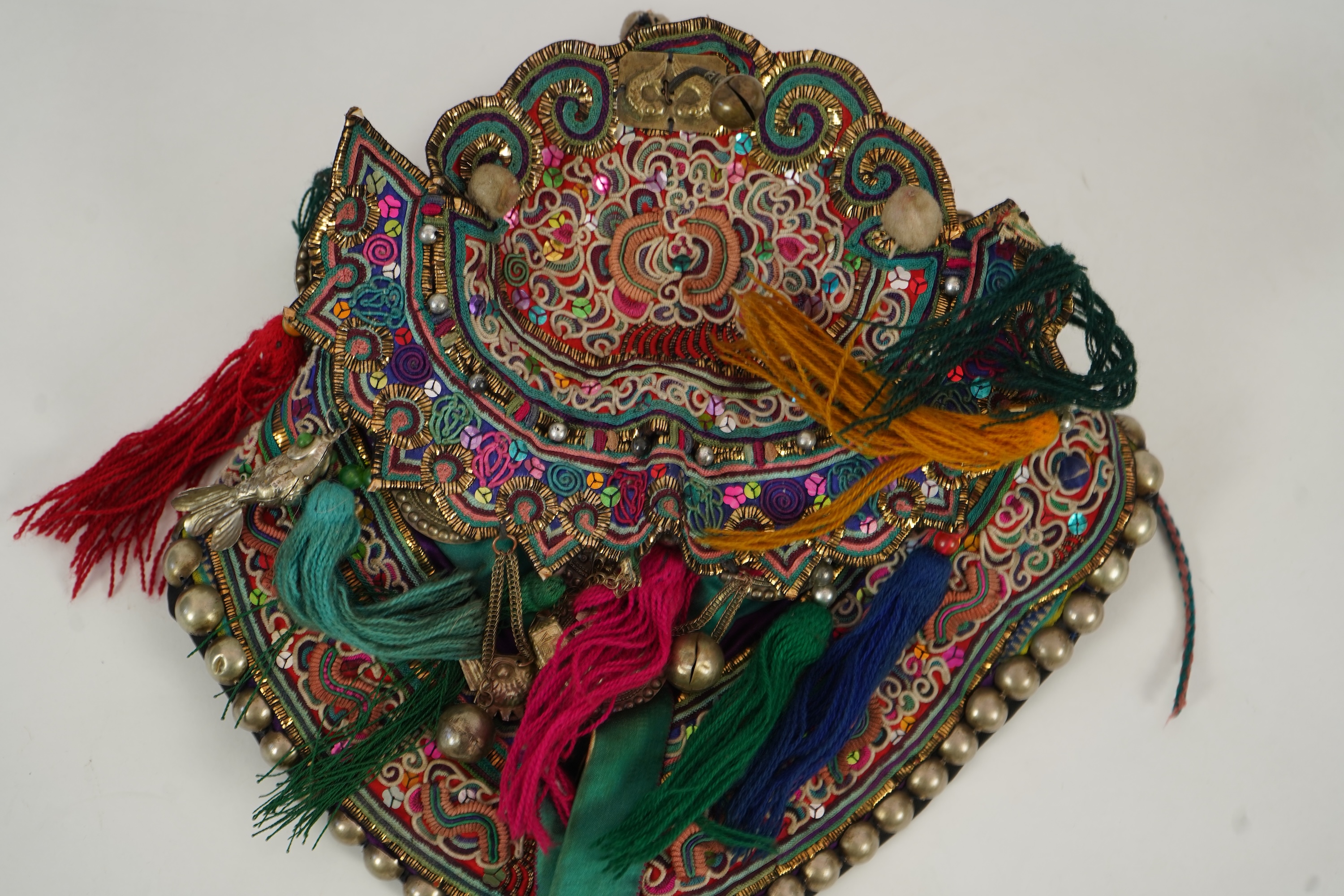Two Chinese embroidered silk wedding skirts, late Qing, five hats, trousers, two skirt panels and two others, collar and a panel
